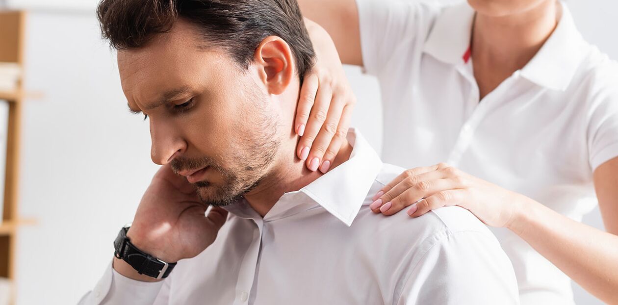 A patient with neck pain during a diagnostic examination